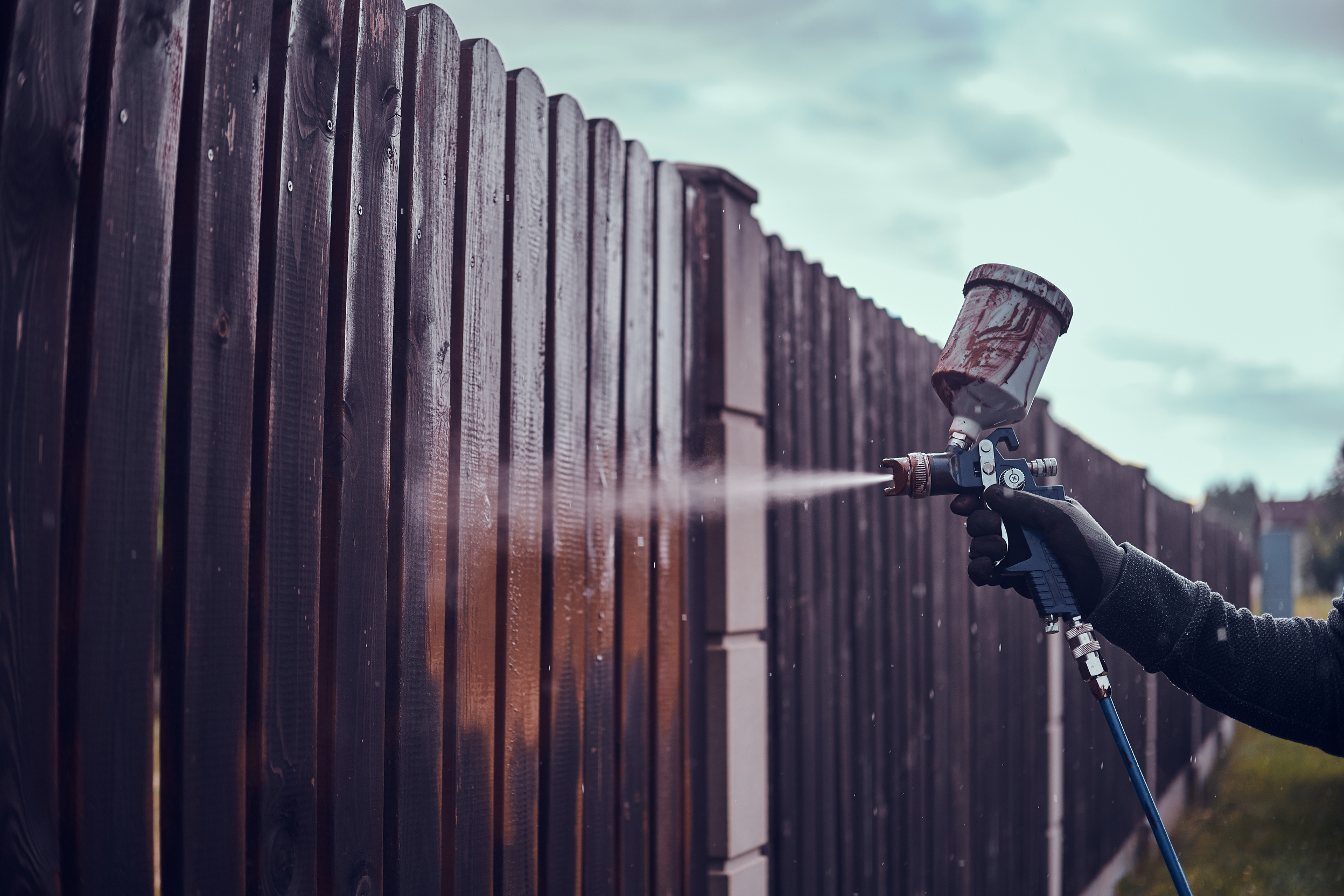 Hand Airbrush Painting a Wooden Fence